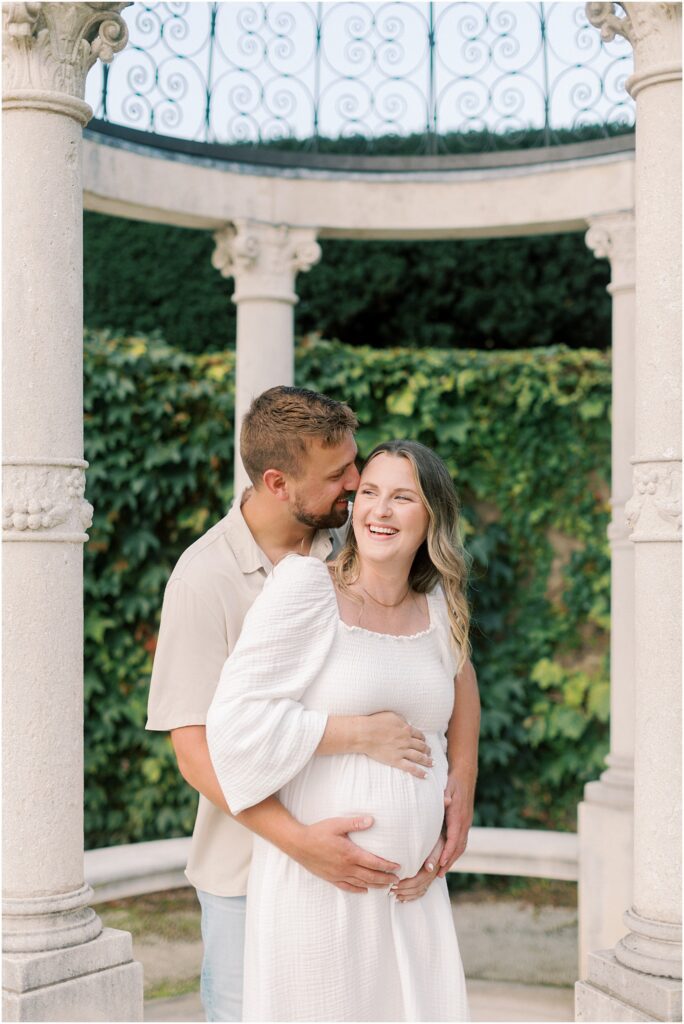 Couple at Longwood Gardens Maternity Session laughing together under a gazebo
