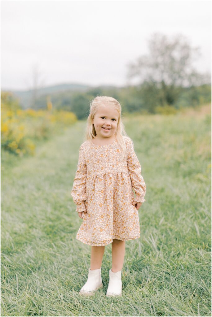 Young girl standing and looking at the camera at a Lancaster Fall Family Session