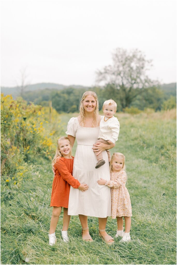 Mother standing with her three children at Middle Creek Wildlife Management in a Lancaster Fall Family Session