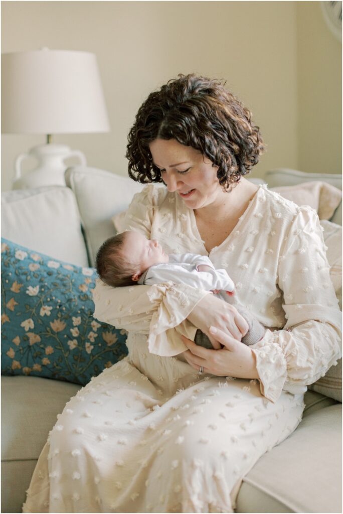 Mother holding newborn son with Angelique Jasmin Photography