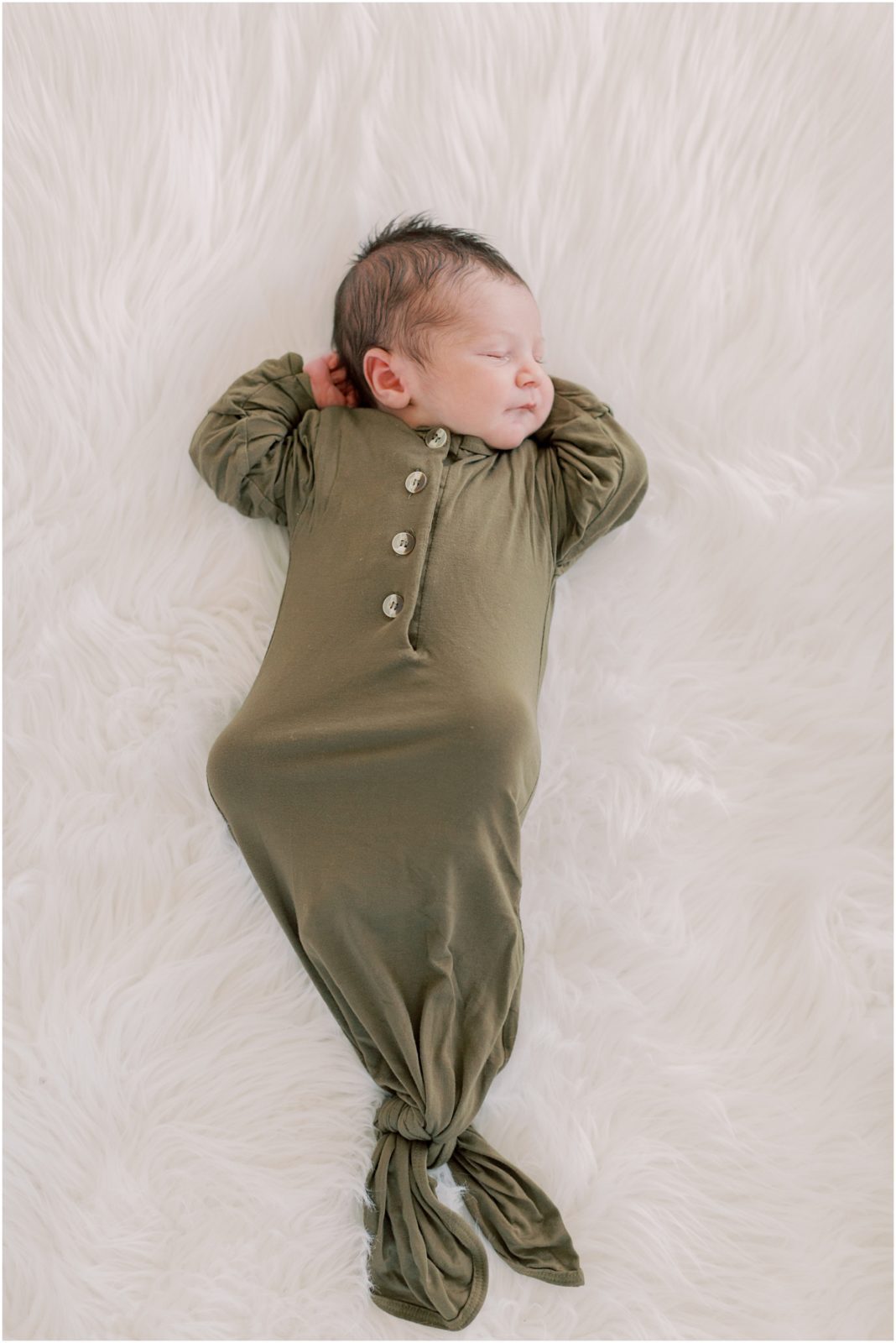 newborn baby boy with green infant gown