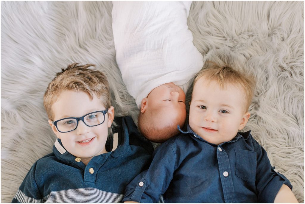 Boys with new baby brother at newborn session