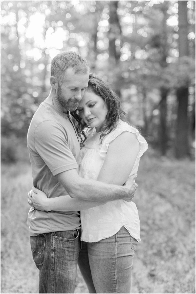 Black and white image of parent's embrace with Angelique Jasmin Photography