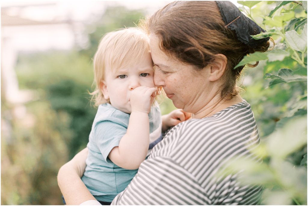 Mother snuggling with toddler at Flower Garden Mini Sessions