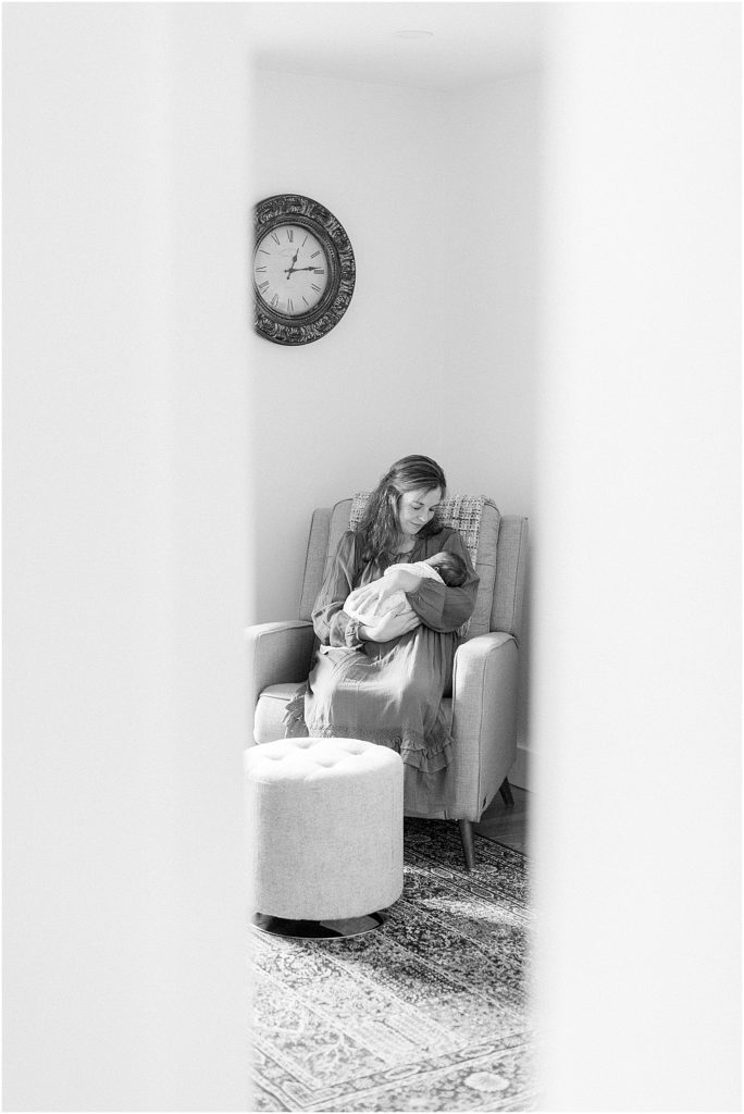 Black and white image of mother rocking a baby