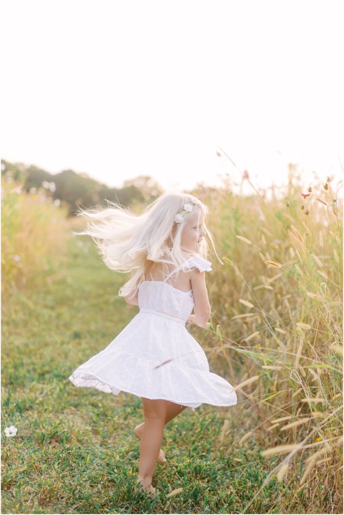 Little girl twirling in flower field session