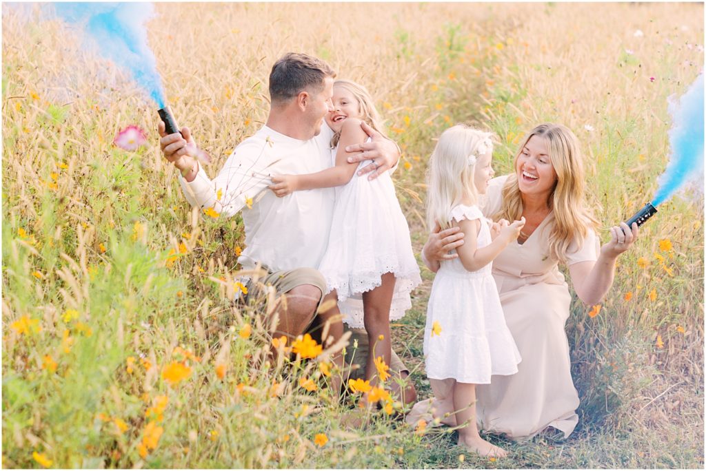 Family with smoke bombs at maternity session