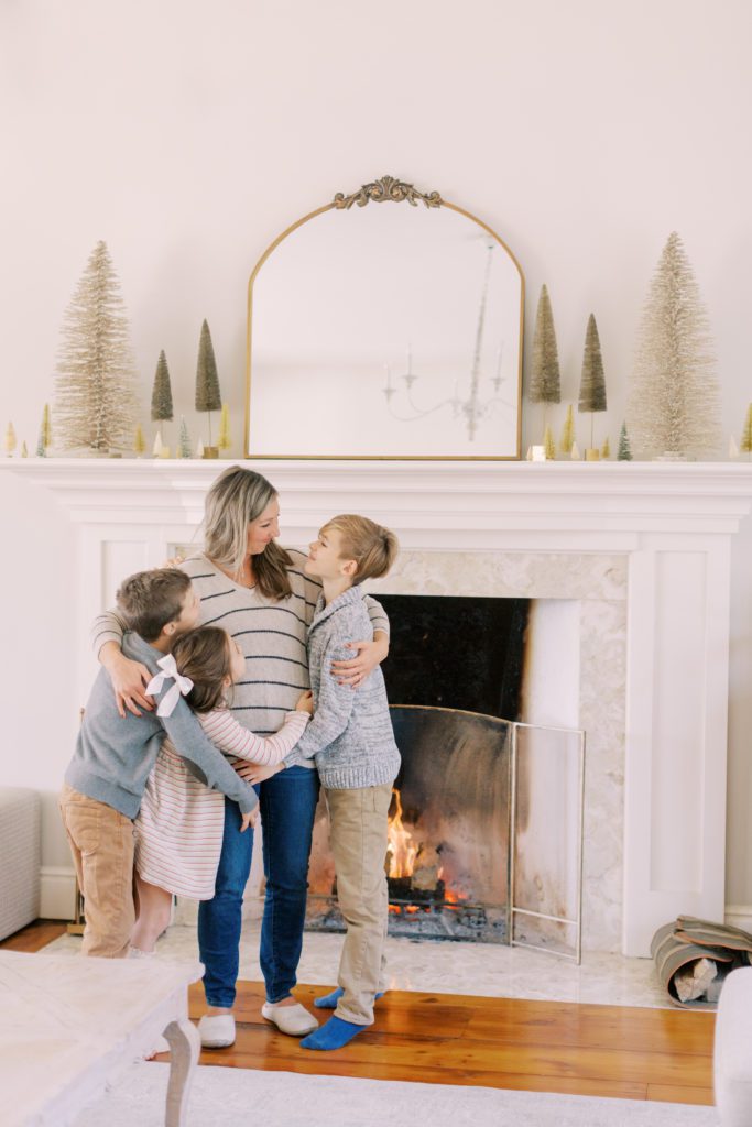 Momma with children by the fireplace