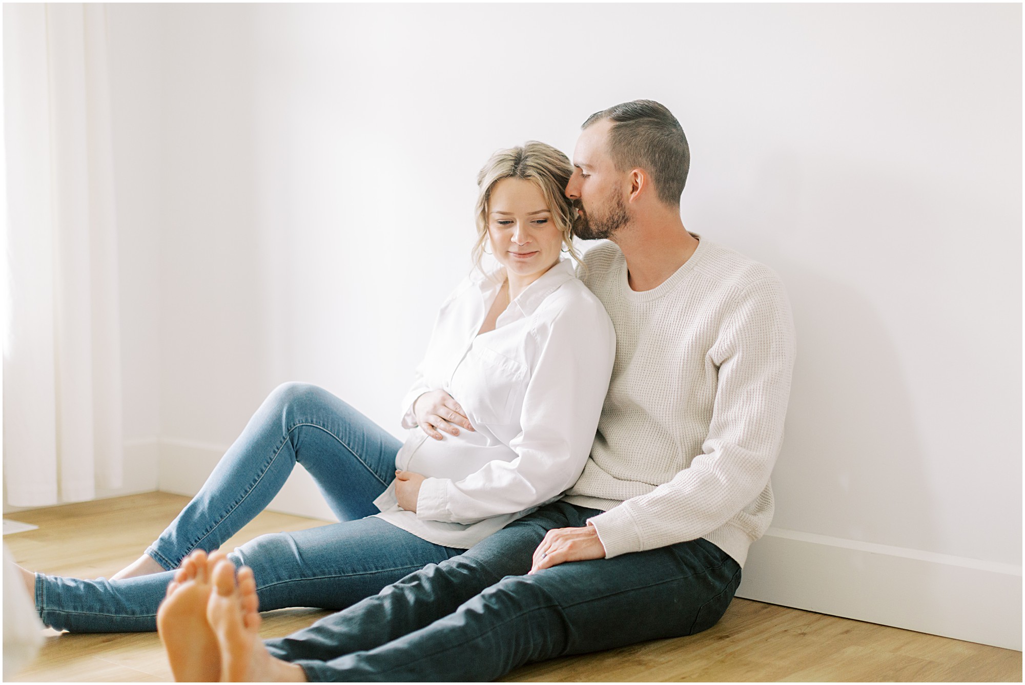 Couple sitting on the floor at maternity session