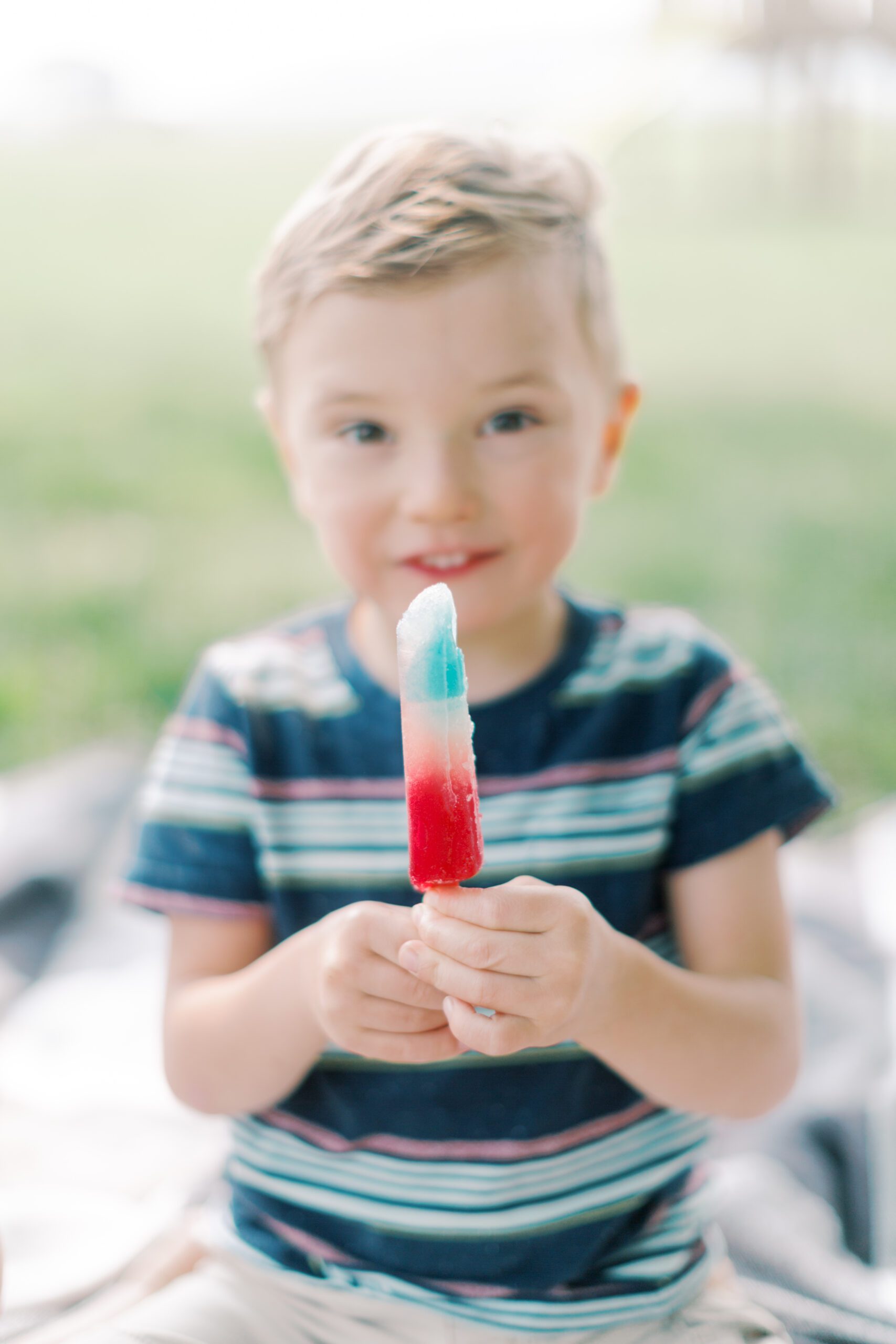 Little boy with red, white and blue popsicle in Summer Bucket List 2023