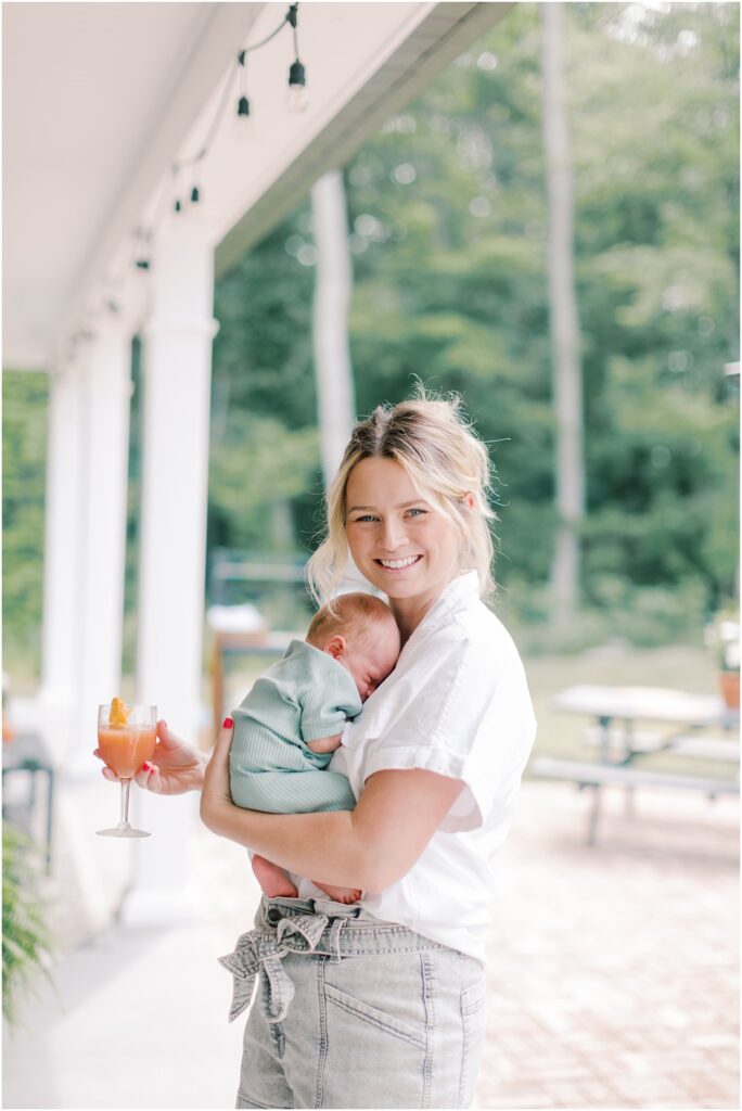 New mama holding her son at woodland themed baby shower