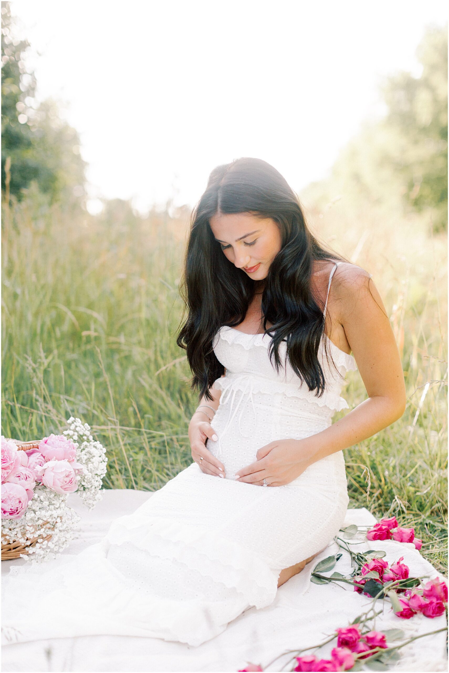 Young mom kneeling on blanket at an intimate maternity session