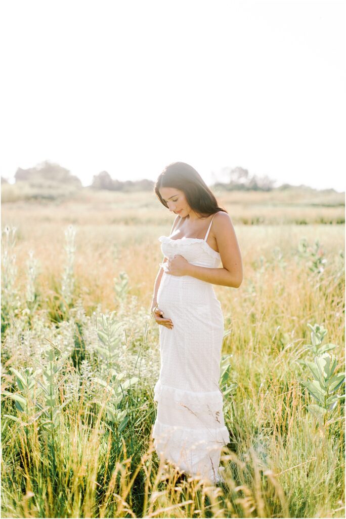 woman in a field at pregnancy session