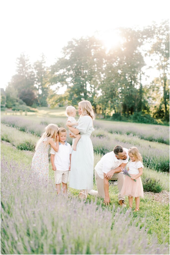 A family interacting with each other in a lavender field