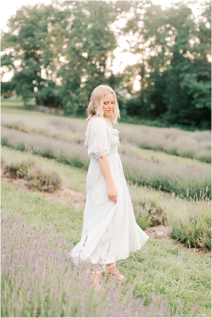 Mother swooshing her dress in a lavender field with Angelique Jasmin Photography