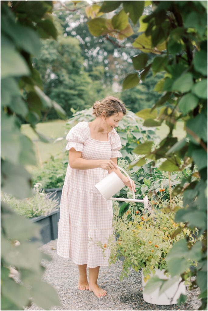 Woman watering her garden in motherhood and gardening with Angelique Jasmin Photography