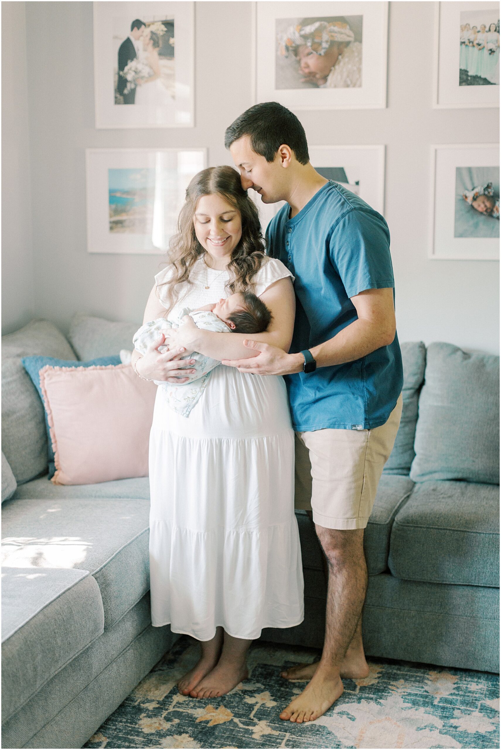 Couple standing in their living room with their newborn in Elizabethtown PA Newborn Photographer