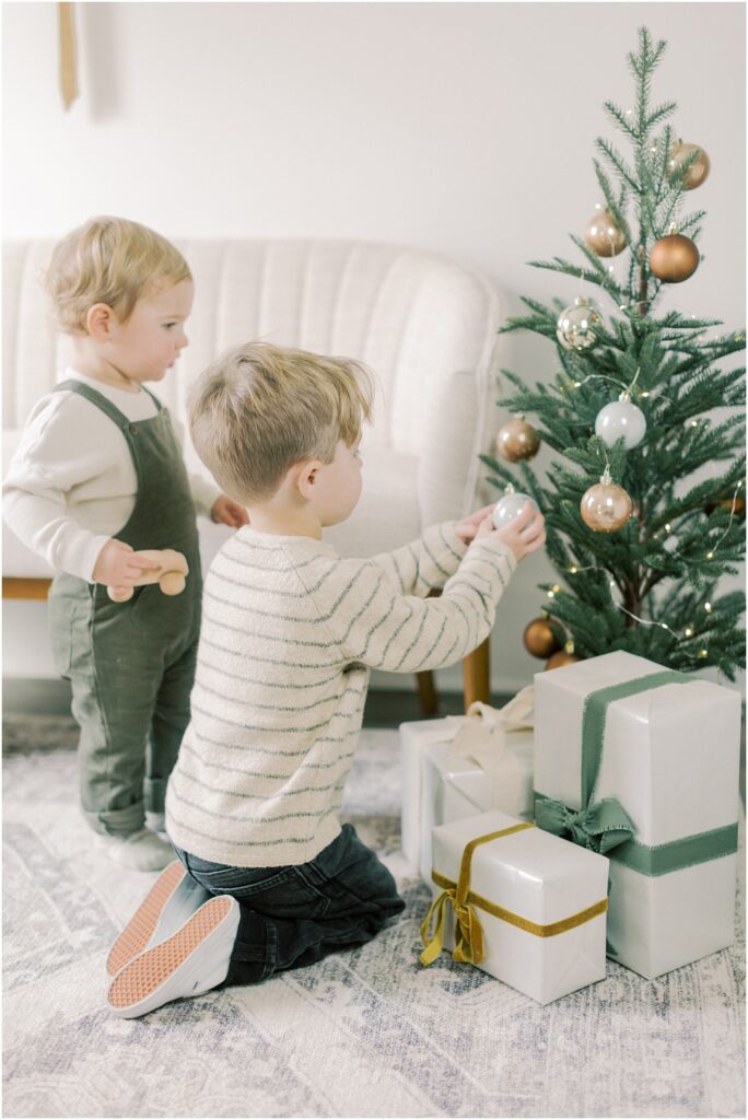 Little boys decorating the tree at Lancaster, PA Christmas Mini Sessions.