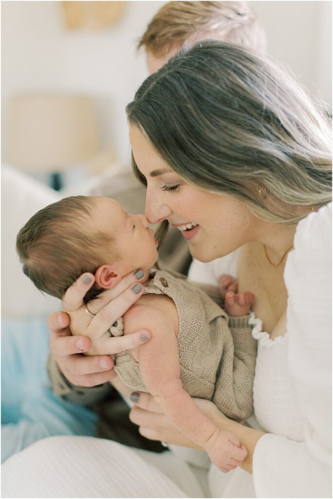 Mother looking at her baby boy nose to nose in a lifestyle newborn photography session with Angelique Jasmin Photography