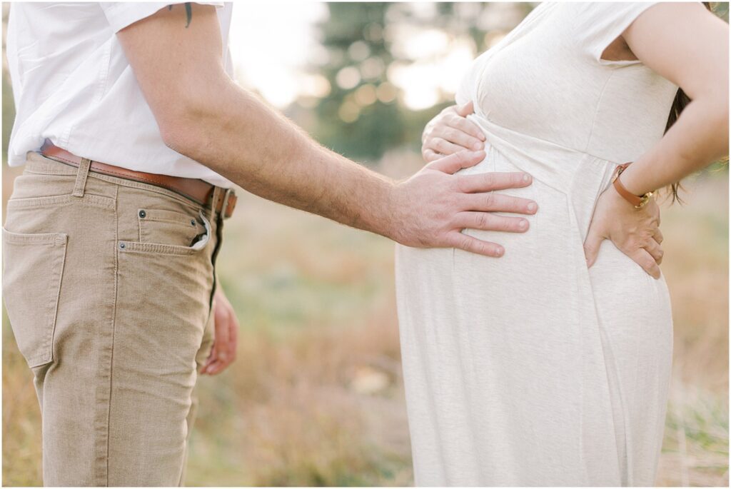 Husband's hands on his wife's pregnant belly