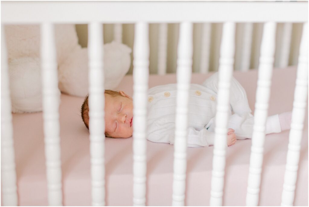 Baby girl laying in her crib